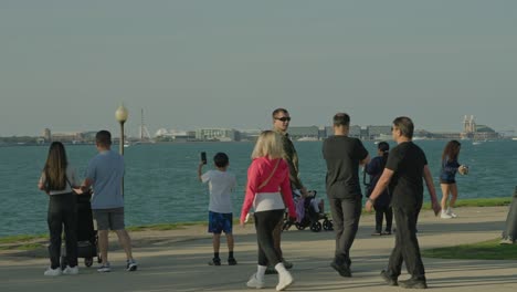 Overwheight-people-on-bicycle-at-Adler-Planetarium-with-Chicago-in-background
