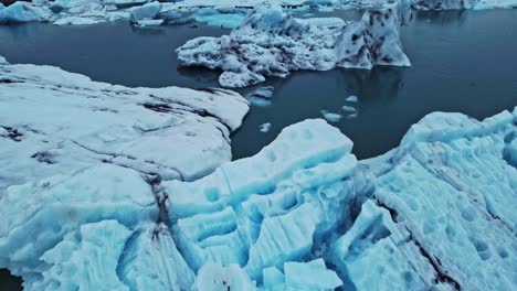 Drone-shot-flying-over-Jökulsárlón-the-glacier-lagoon-Iceland-in-summer