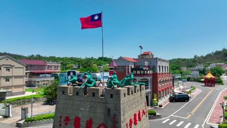 Aerial-Orbiting-shot-of-waving-Taiwan-flag-of-china-on-island-of-Kinmen-during-sunny-day