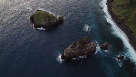 Drone-Orbitando-Sobre-El-Océano-De-Una-Costa-Escarpada-Y-Rocas-Aisladas