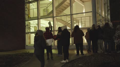 Youngstown-State-University-students-gather-peacefully-on-a-cold-night-holding-signs-in-protest-to-the-cuts-to-the-arts-program-at-the-Dana-School-of-Music