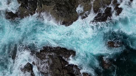 Drone-rising-revealing-waves-crashing-and-rocky-islands