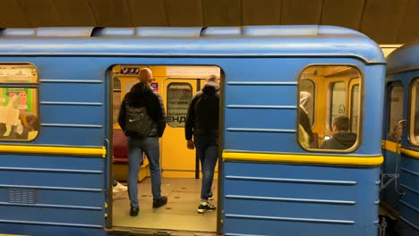 People-taking-an-underground-subway-metro-tube-in-Kyiv-Ukraine,-quick-transportation-around-a-city,-4K-shot