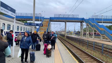 Refugiados-Ucranianos-Esperando-Que-Llegue-Un-Tren-A-La-Estación-De-Tren-De-Chelm-En-Polonia,-Personas-Que-Huyen-Y-Escapan-De-La-Guerra,-Toma-Estática-De-4k