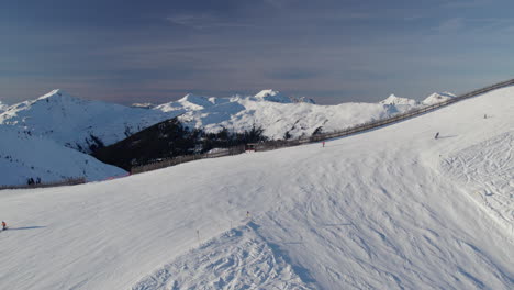 Winter-Landscape-At-Ski-Resort-With-Skiers-In-Saalbach-Hinterglemm,-Austria---Aerial-Shot