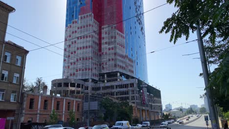 Bombed-and-destroyed-tall-skyscraper-building-with-broken-glass-windows-in-Kyiv-Ukraine,-critical-war-damage-in-the-city-capital,-4K-shot