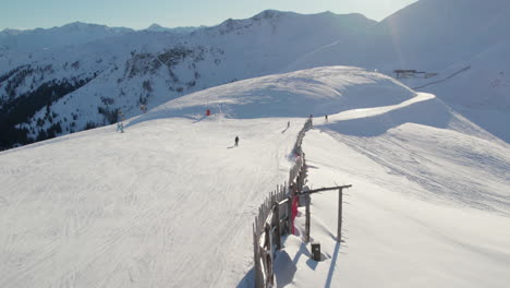 Skiers-And-Snowboarders,-Ski-Resort-In-Saalbach-Hinterglemm,-Austria---Aerial-Drone-Shot