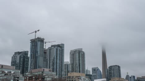 Timelapse-of-clouds-by-skyscrapers-and-construction-cranes-in-Toronto