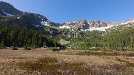 Static-shot-of-marsh-and-a-pond-below-large-mountains