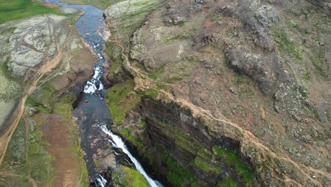Glymur-waterfalls-in-deep-valley-of-Iceland,-aerial-drone-view