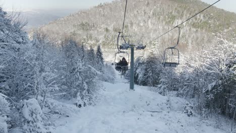 Pov-Riding-ski-lifts-slow-motion-sunny-winter-snow-day-ski-resort