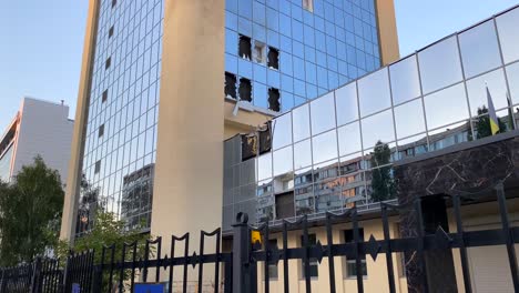 Rockets-bombed-and-destroyed-tall-skyscraper-building-with-broken-glass-windows-on-Solomianska-Street-in-Kyiv-Ukraine,-critical-war-damage-in-the-city-capital,-Russia-attacks-Ukraine,-4K-shot