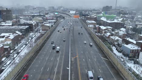Aerial-flyover-of-four-lane-highway-in-winter
