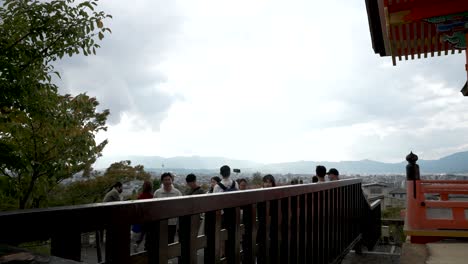 Wooden-Railing-With-Tourists-On-Other-side-At-Kiyomizu-dera-Temple-In-Kyoto,-Japan