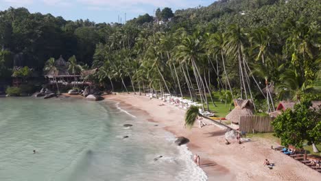 Aerial-Flying-Along-Sairee-Beach-Lined-With-Tropical-Palm-Trees-And-Waves-Breaking