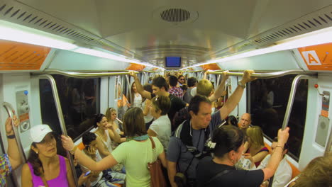 Symmatric-fisheye-interior-of-crowded-train-travelling-underground