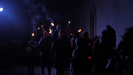 People-with-torches-march-through-the-city,-Memorial-Day-of-the-Fallen-Soldiers