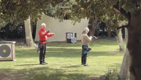 Older-man-and-woman-practice-archery