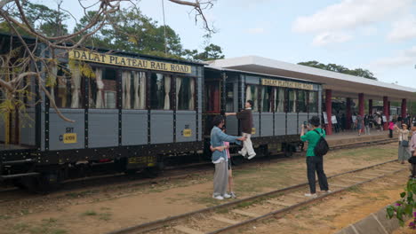 Da-Lat-Railway-Station---Tourists-Take-Photos-and-Explore-Old-Vintage-Train-Wagon-Standing-on-Tracks