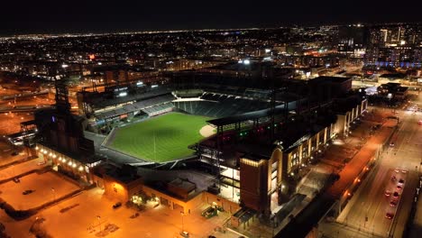 Slow-aerial-drone-orbit-of-Coors-Field-baseball-stadium-in-Denver,-Colorado,-USA-at-night-time