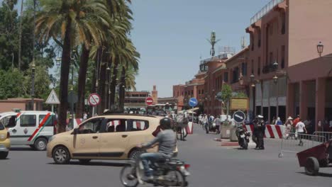 Busy-street-with-Tourist-and-locals-on-front-of-Jamaa-El-Fna-square-in-Marrakech