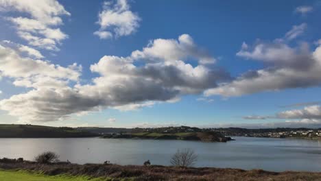 Timelapse-of-clouds-over-Kinsale,-Ireland-sliding-from-left-to-right,-on-a-sunny-winter-day