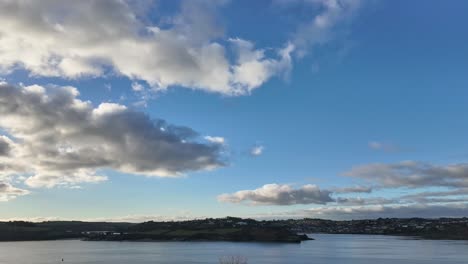 Timelapse-footage-of-clouds-fast-moving-over-blue-sky-above-Kinsale,-Ireland