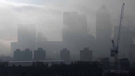 Steam-rises-from-the-rooftops-of-skyscrapers-enveloped-in-freezing-fog-at-Canary-Wharf’s-financial-district-and-an-East-End-estate