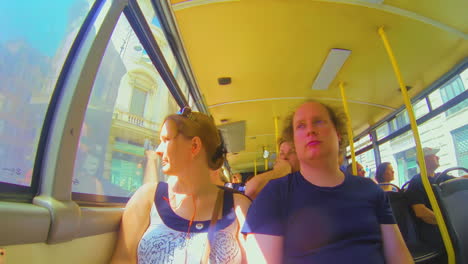 Tourist-couple-sitting-in-Italian-bus-during-spring-in-t-shirt-fisheye-pov