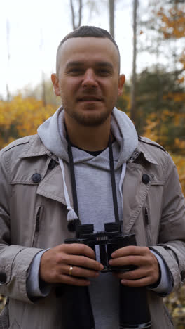 Man-with-binoculars-at-the-forest