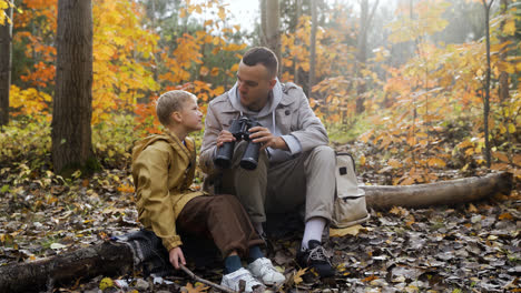 Father-and-son-sitting-at-the-forest