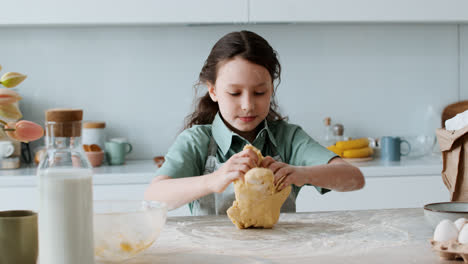 Girl-kneading-a-dough