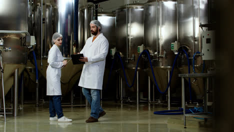 Man-and-woman-doing-control-at-brewery