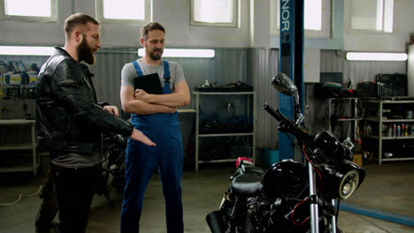 Mechanic-and-rider-talking-at-the-garage