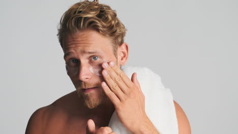 Man-with-eye-patches-holding-towel-on-his-shoulder