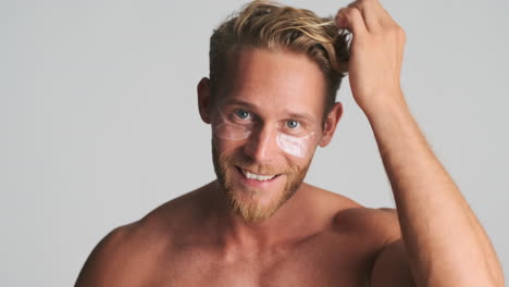 Blond-handsome-man-using-eye-patches