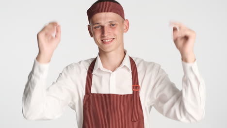 Happy-blue-eyes-man-celebrating-in-baker-uniform