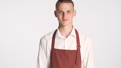 Young-man-in-waiter-uniform-smiling