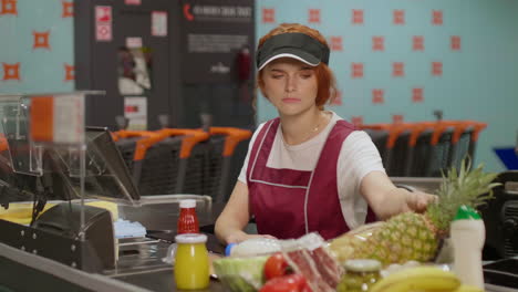 Young-serious-sales-clerk-woman-working-in-a-supermarket