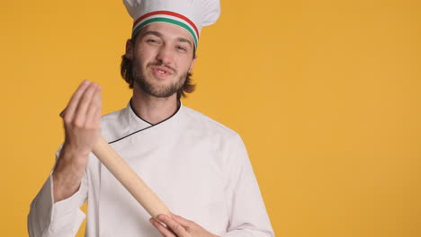 Caucasian-chef-in-front-of-camera-on-yellow-background.
