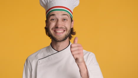 Caucasian-chef-in-front-of-camera-on-yellow-background.