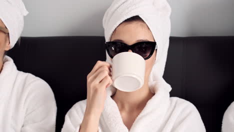 Caucasian-girls-drinking-coffee-in-hotel-room.