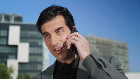 Businessman-talking-on-cellphone-outdoors