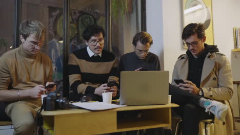 Businessmen-using-smartphones-in-cafe