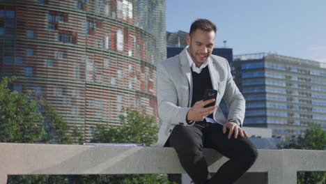 Businessman-having-video-chat-on-smartphone-at-street