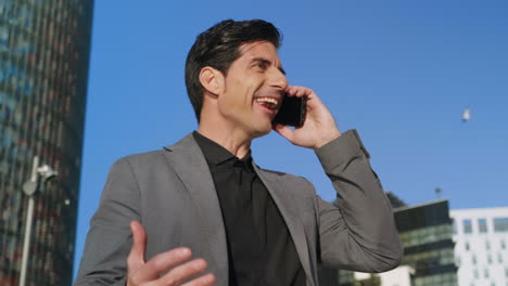 Businessman-talking-mobile-phone-at-street