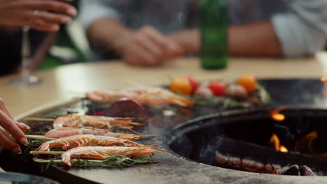 Woman-cooking-seafood-on-grill