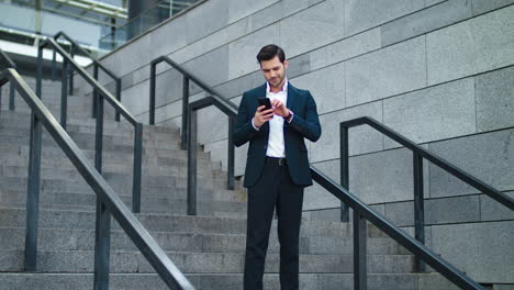 Business-man-using-phone-at-stairs-outdoor