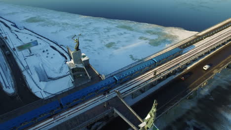Drone-view-of-subway-train-driving-on-outdoor-railways