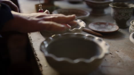 Woman-preparing-clay-bowls-in-pottery-workshop